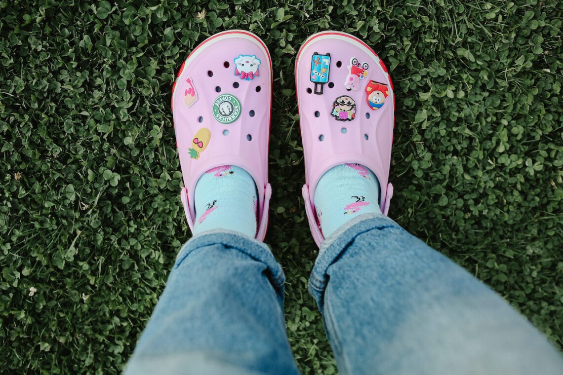 Stylish pink crocs on a women feet