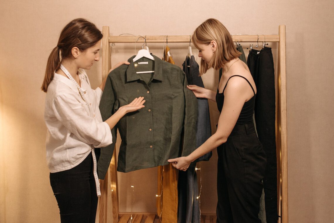 Two women looking at green shirt